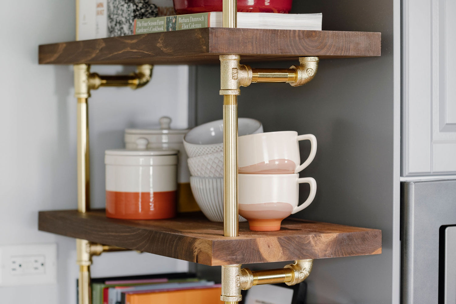 close up photo of brass plated pipes and walnut shelves | Soil & Oak 