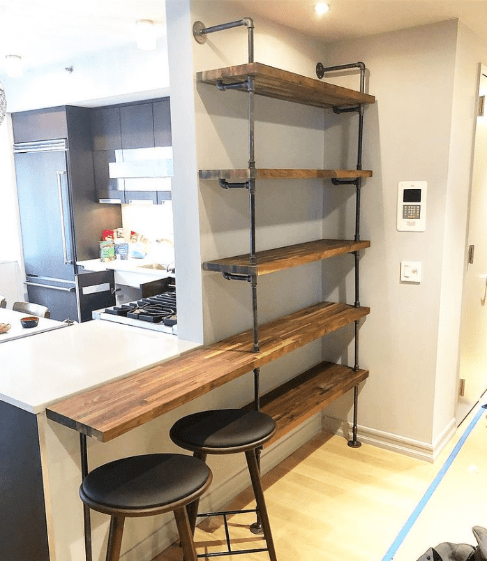 Custom bookshelves with built in countertop with black pipes and walnut butcher block shelves | Soil & Oak