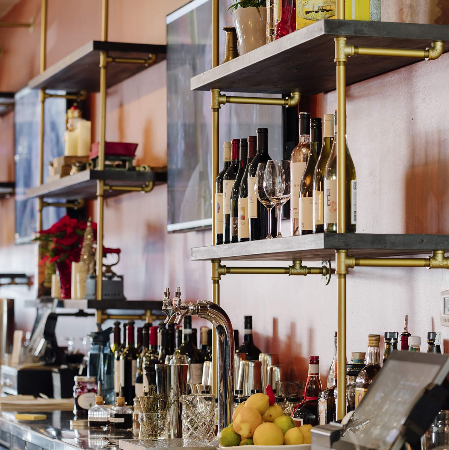 Side view of counter to wall unit with brass plated pipes and dark stained shelves | Soil & Oak