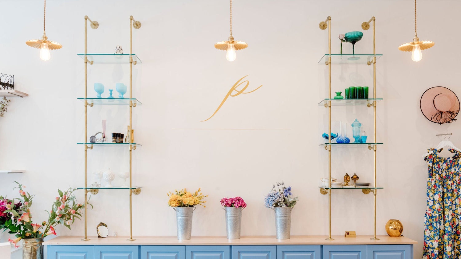 Modern interior design with Soil & Oak custom shelves, flowers, and blue cabinets.