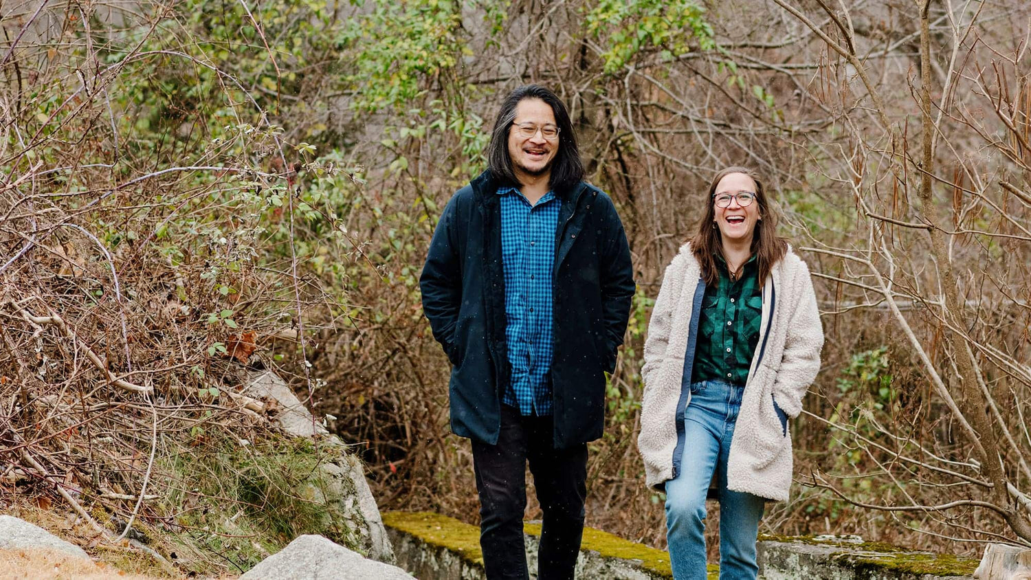 Founders Jay Lee and Caroline Coolidge laughing while walking in the woods | Soil & Oak