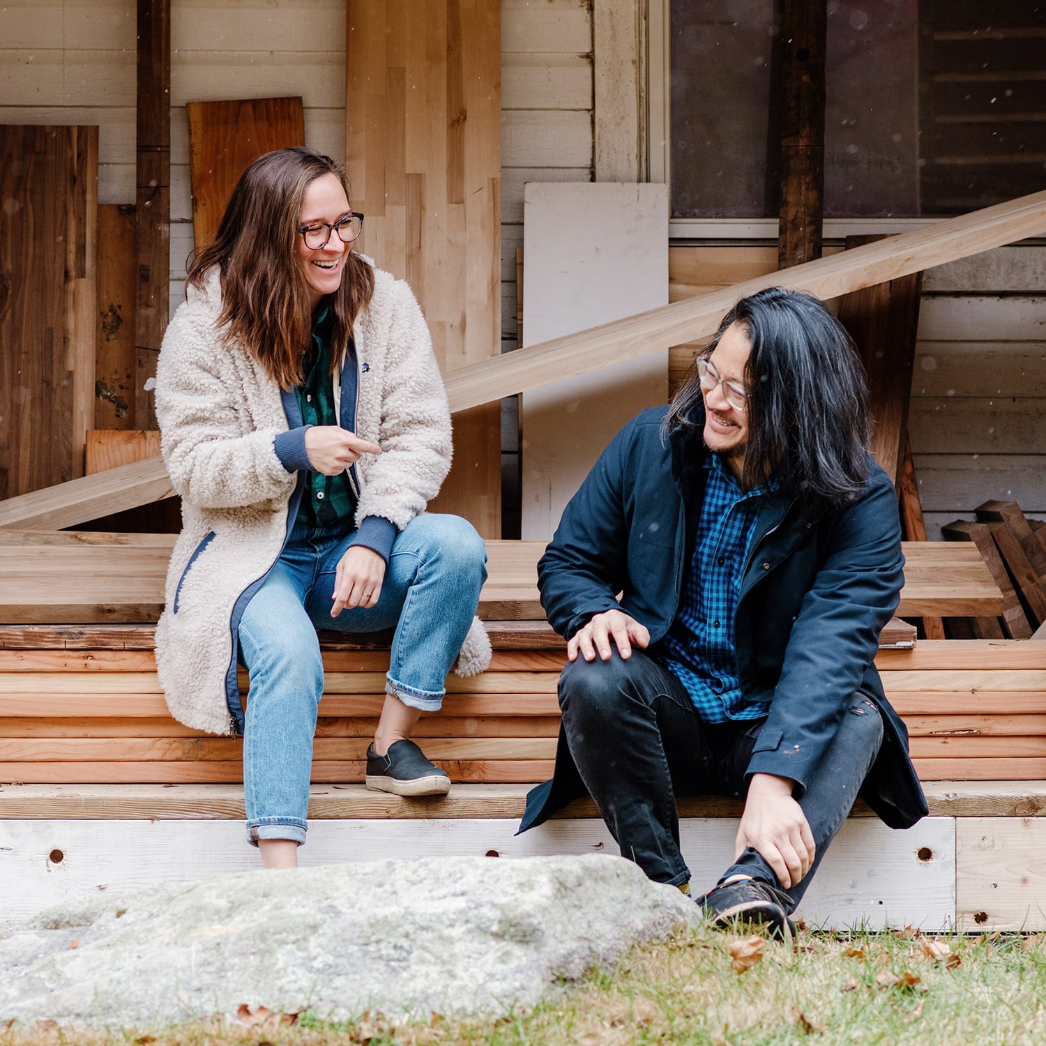 founders Jay Lee and Caroline Coolidge sitting in front of shelving materials | Soil & Oak