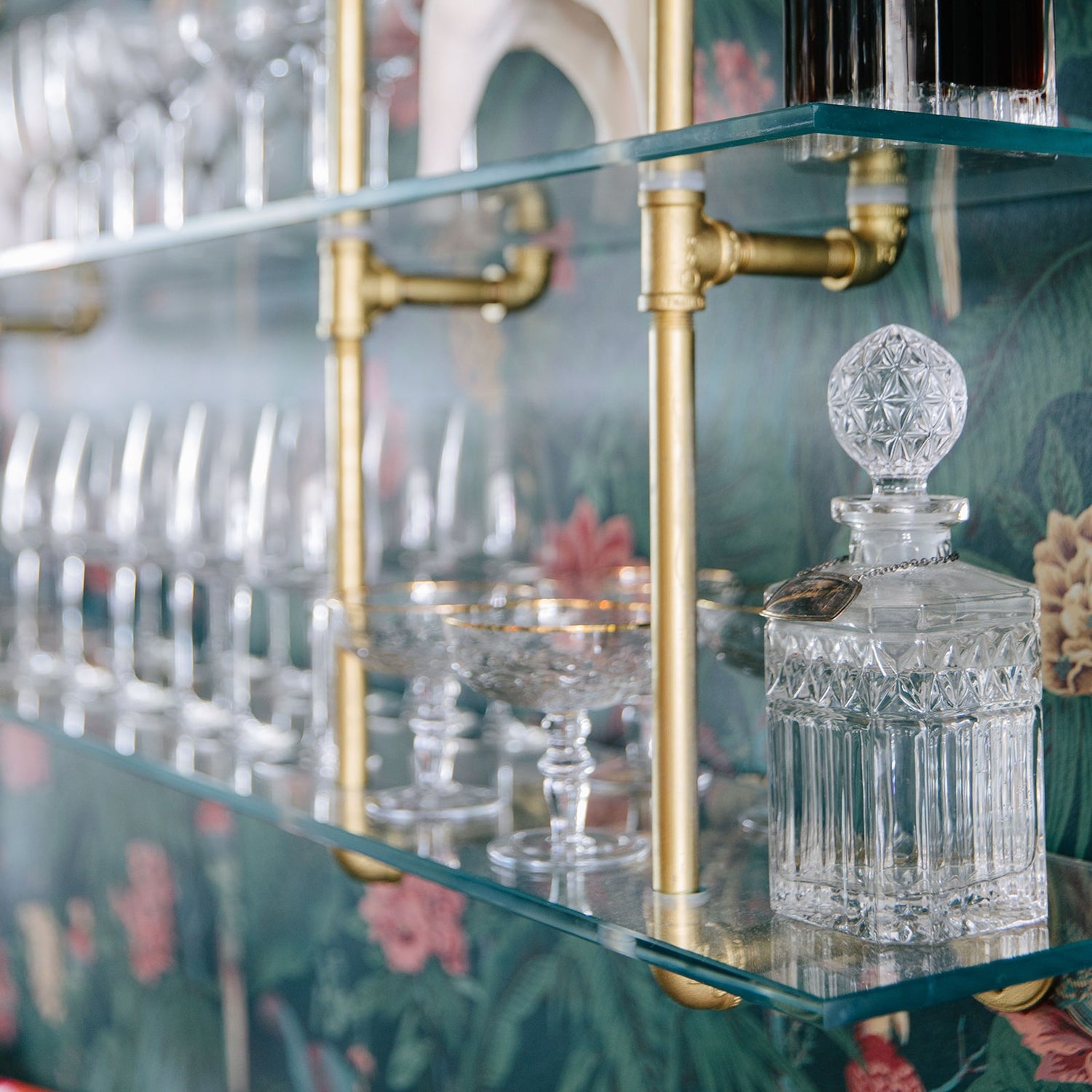 close up photo of brass plated pipes with glass shelves | Soil & Oak