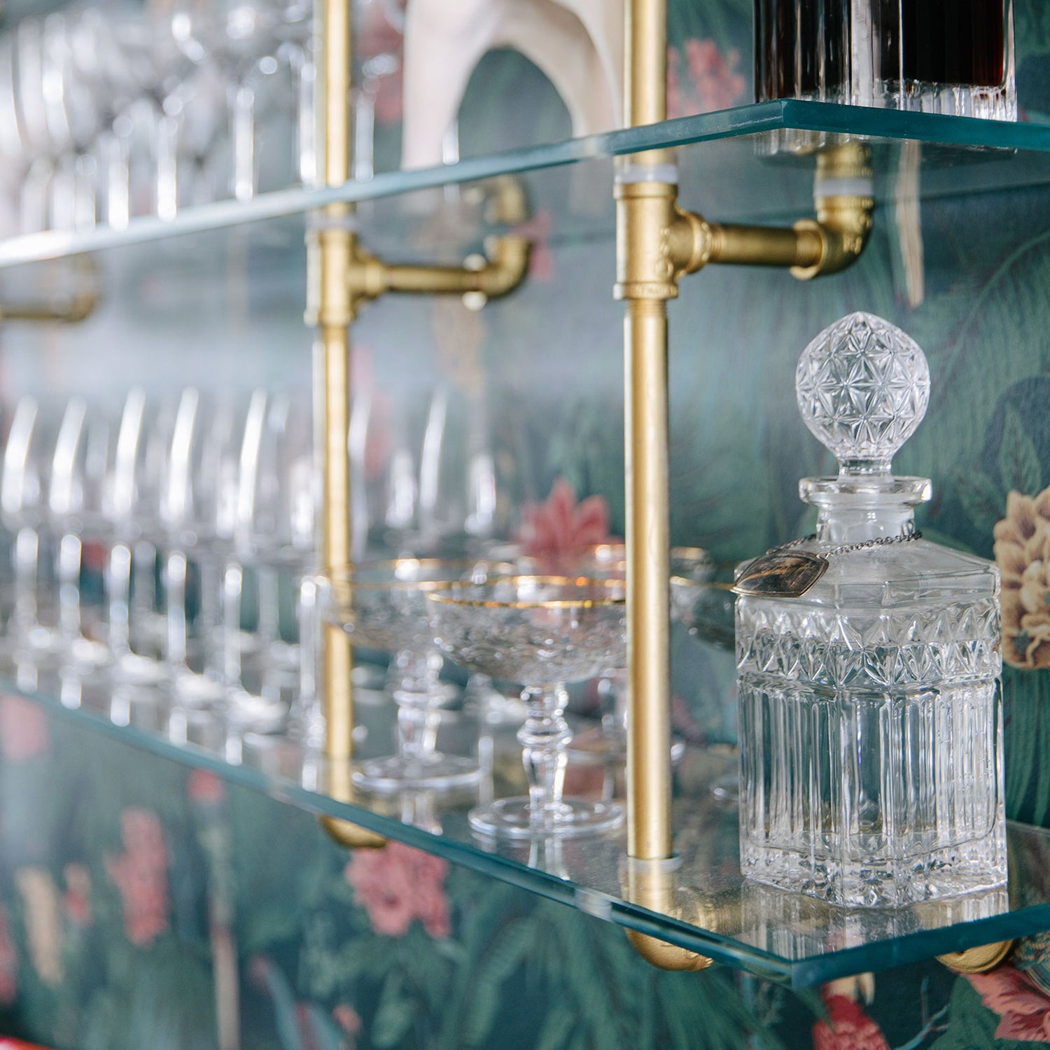 close up photo of brass plated pipes with glass shelves | Soil & Oak 