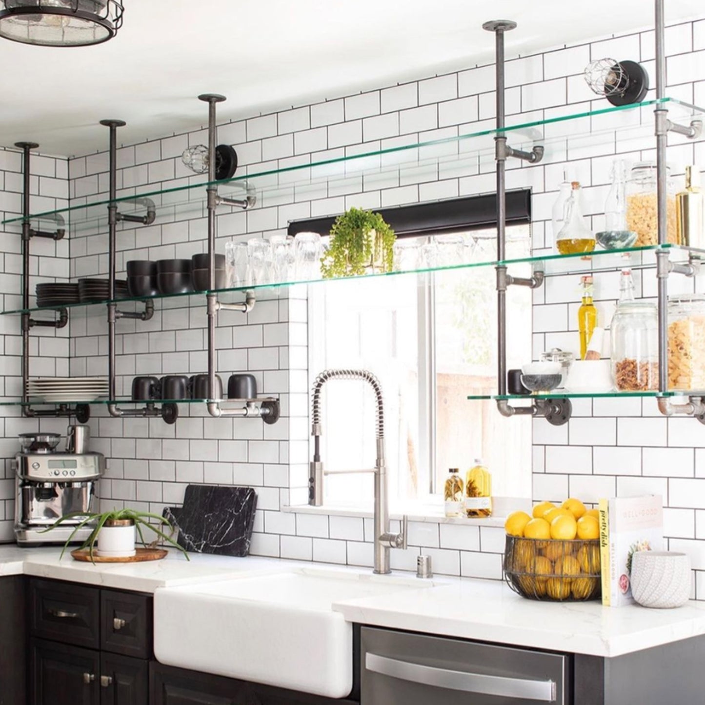 ceiling to wall bar and kitchen shelving with black pipes and glass shelves in a subway tiled kitchen | Soil & Oak