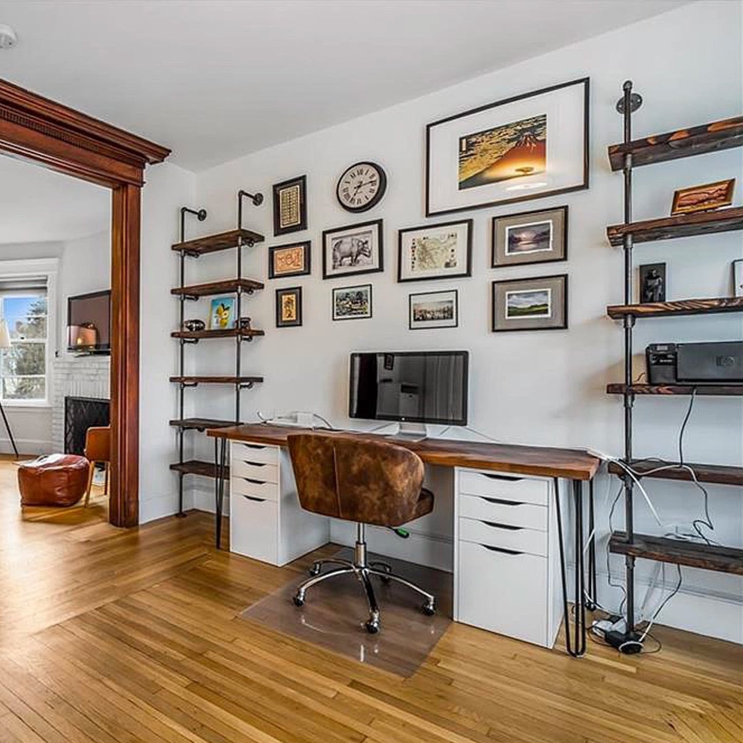 two black steel pipe with oak wood shelves on each side of a desk | Soil & Oak