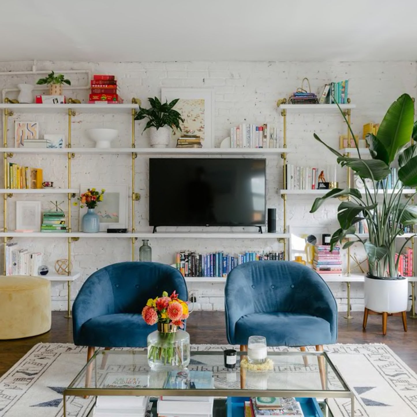 brass plated pipe with painted white wood shelves in living room with white brick wall | Soil & Oak