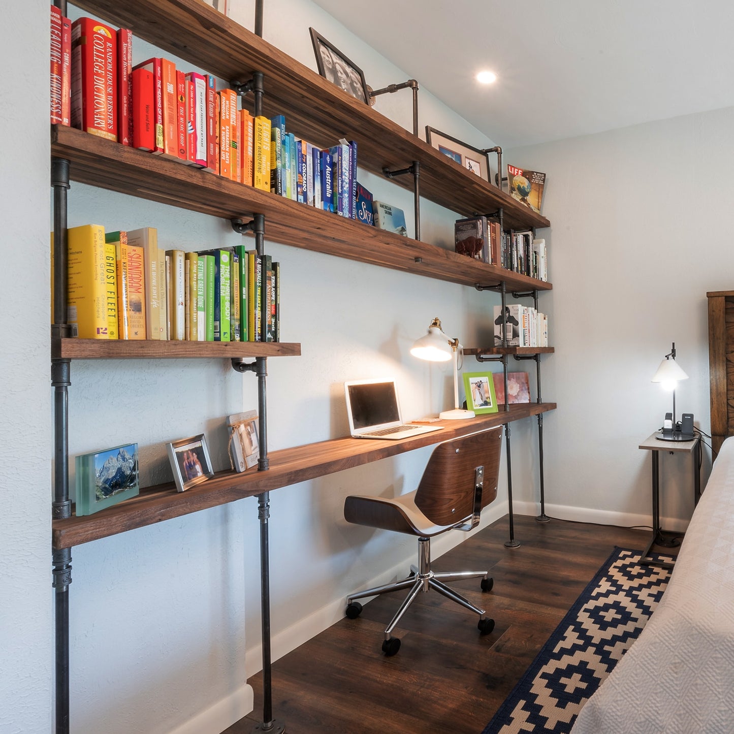 built-in desk with black steel pipes and American walnut butcher block wood shelves in a bedroom | Soil & Oak