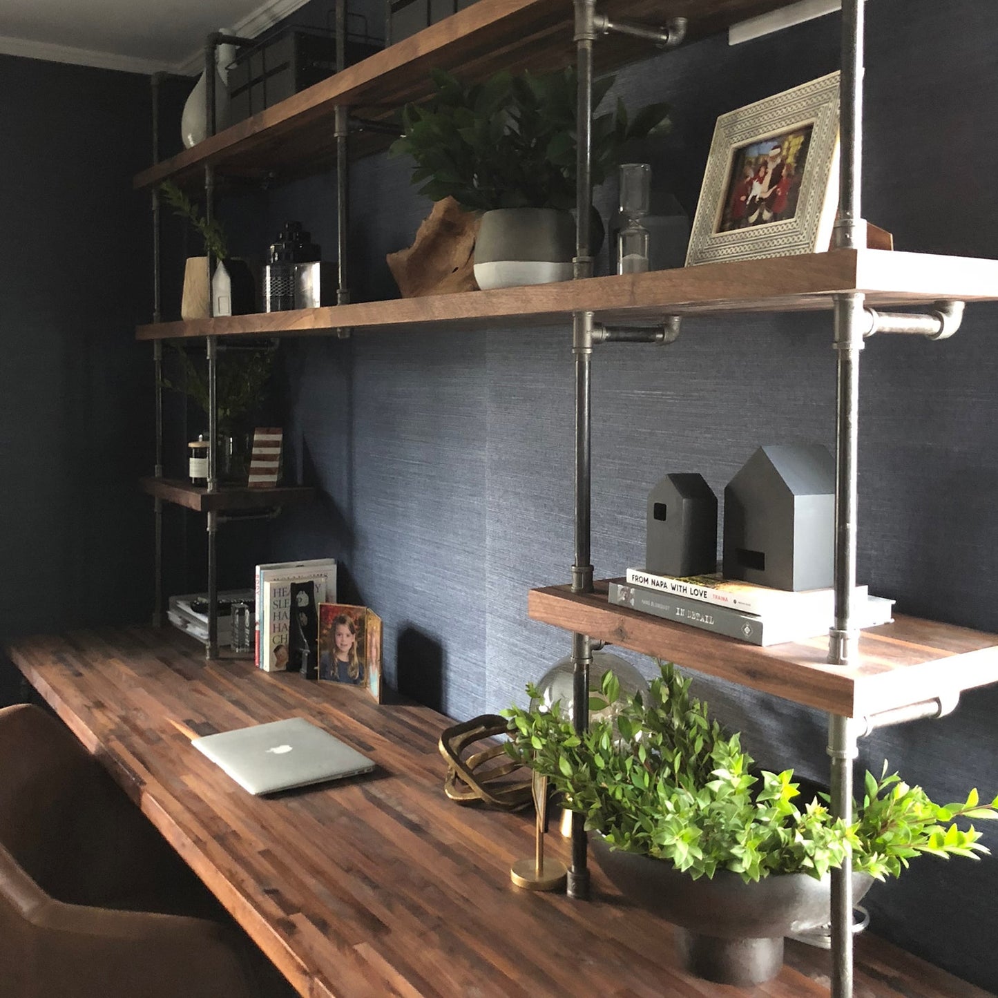 built-in desk with black steel pipes and American walnut wood shelves in a home office | Soil & Oak