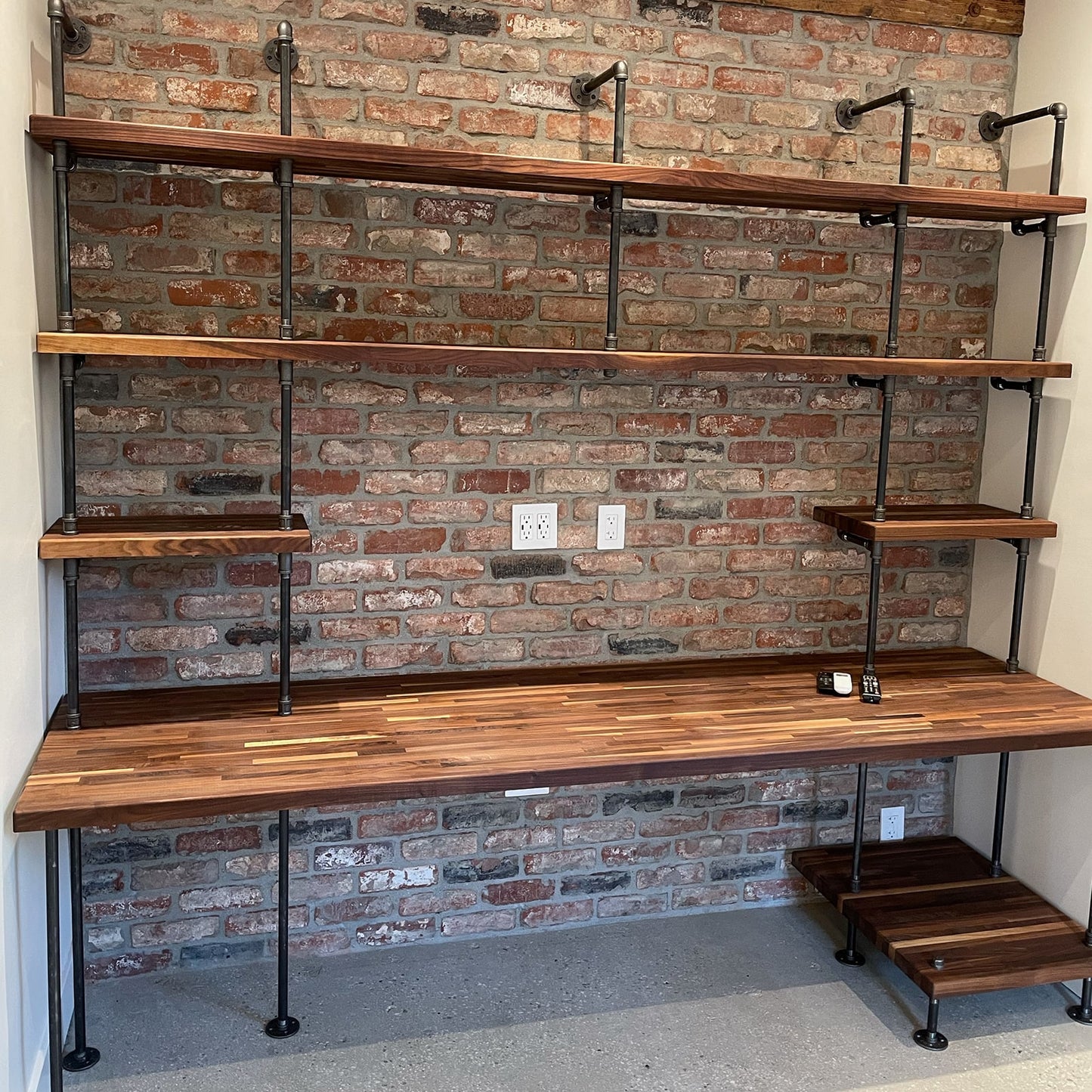 built-in desk with black steel pipes and American walnut wood butcher block shelves in a home office and a printer shelf | Soil & Oak