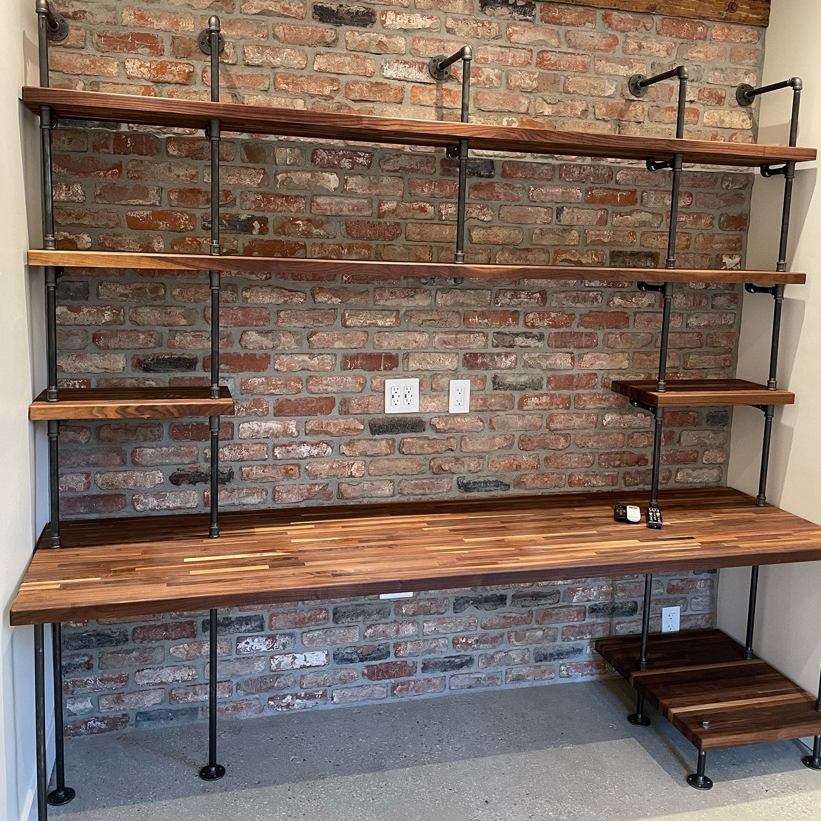 built-in desk with black steel pipes and American walnut wood butcher block shelves in a home office and a printer shelf | Soil & Oak