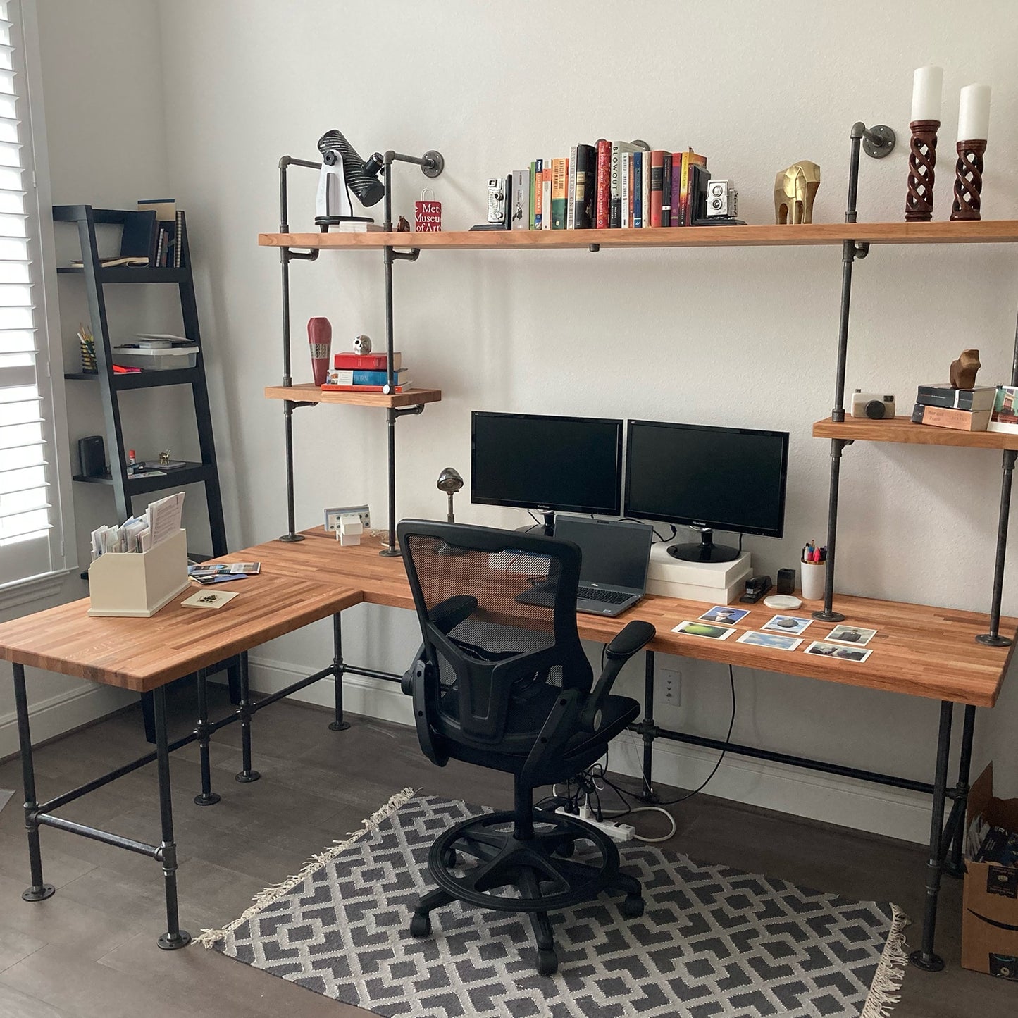 custom bookshelf and built-in desk with black pipes and oak butcher block shelves | Soil & Oak