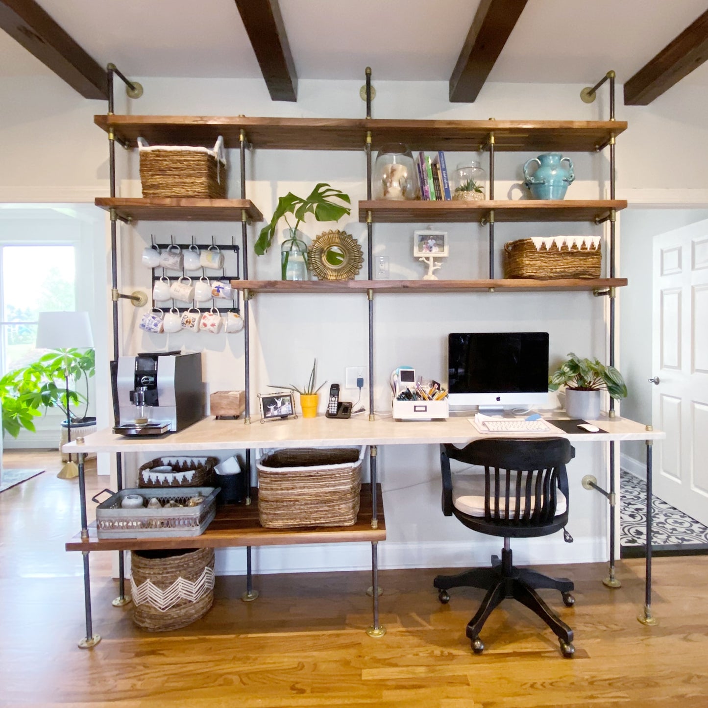custom bookshelf and built-in desk with black pipes and brass plated fittings and walnut shelves with a marble desk top | Soil & Oak