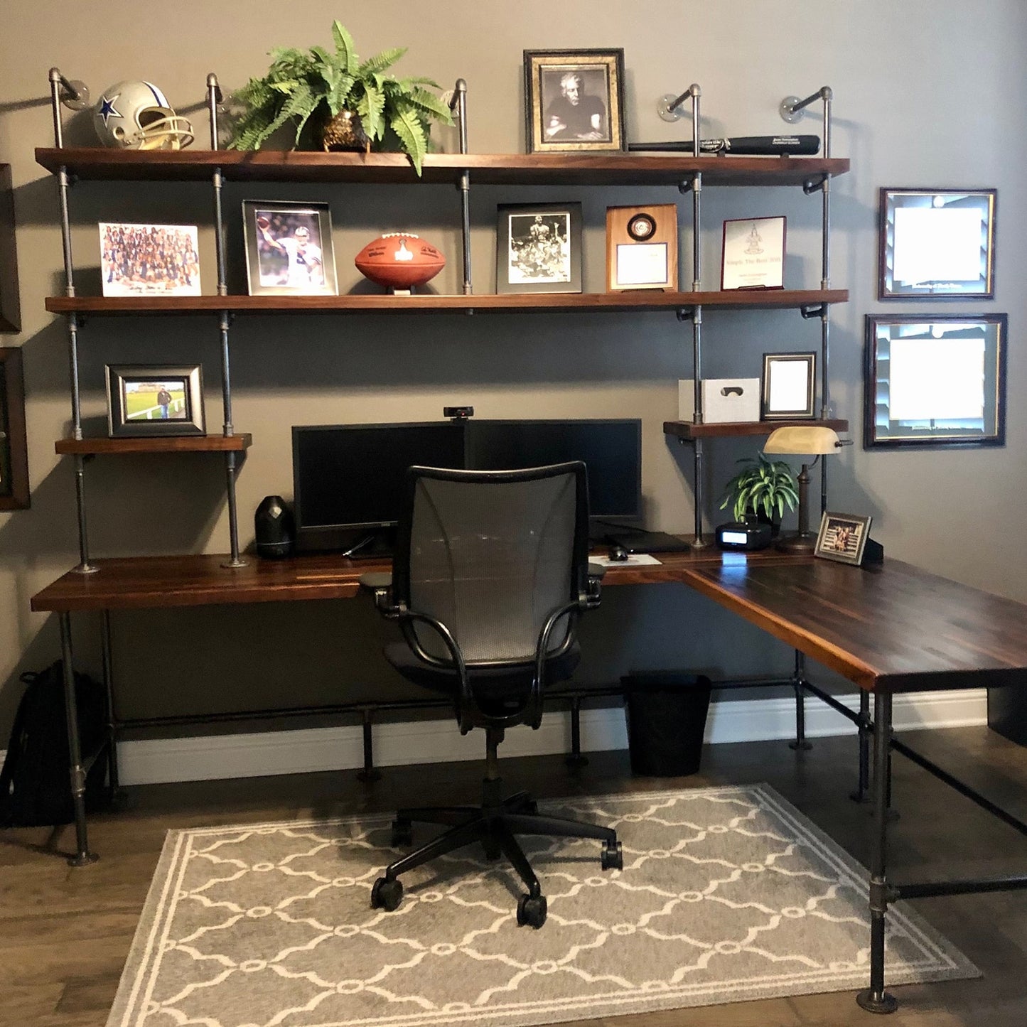 Built-in desk with black pipes and dark stained walnut shelves and table top | Soil & Oak