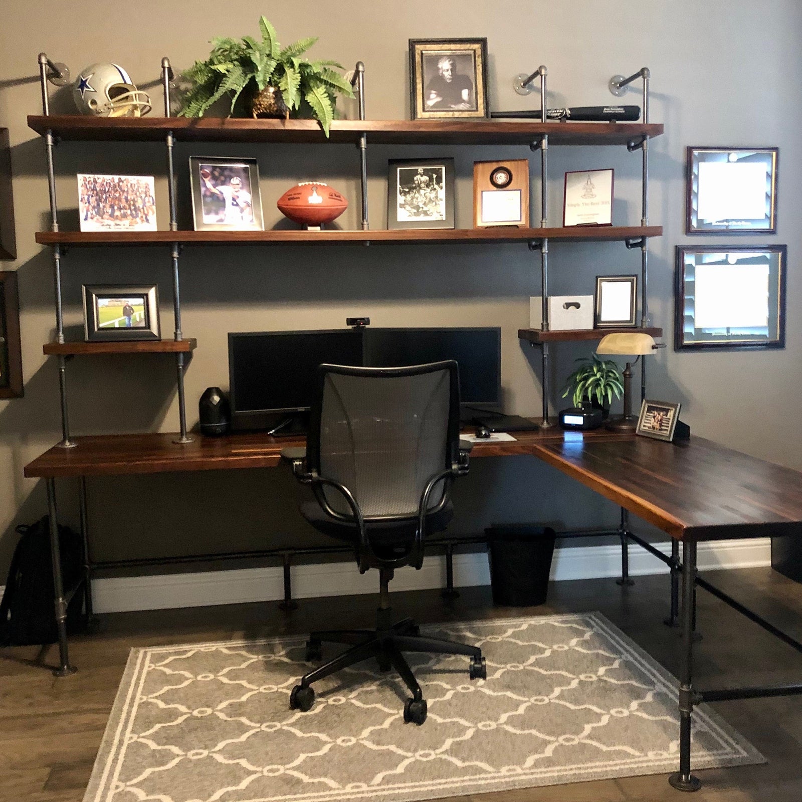 Built-in desk with black pipes and dark stained walnut shelves and table top | Soil & Oak
