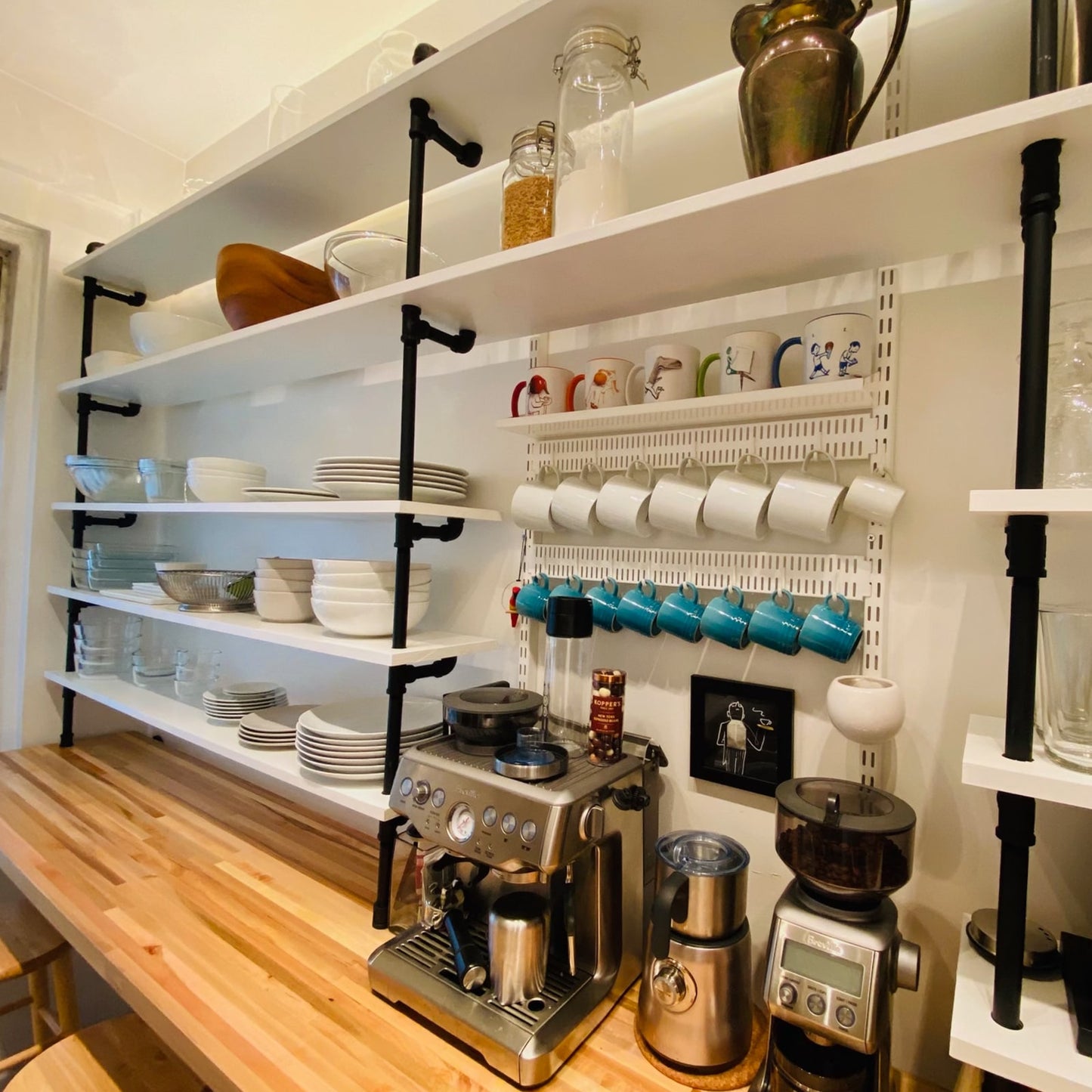 kitchen counter to wall unit with black pipes and white shelves | Soil & Oak