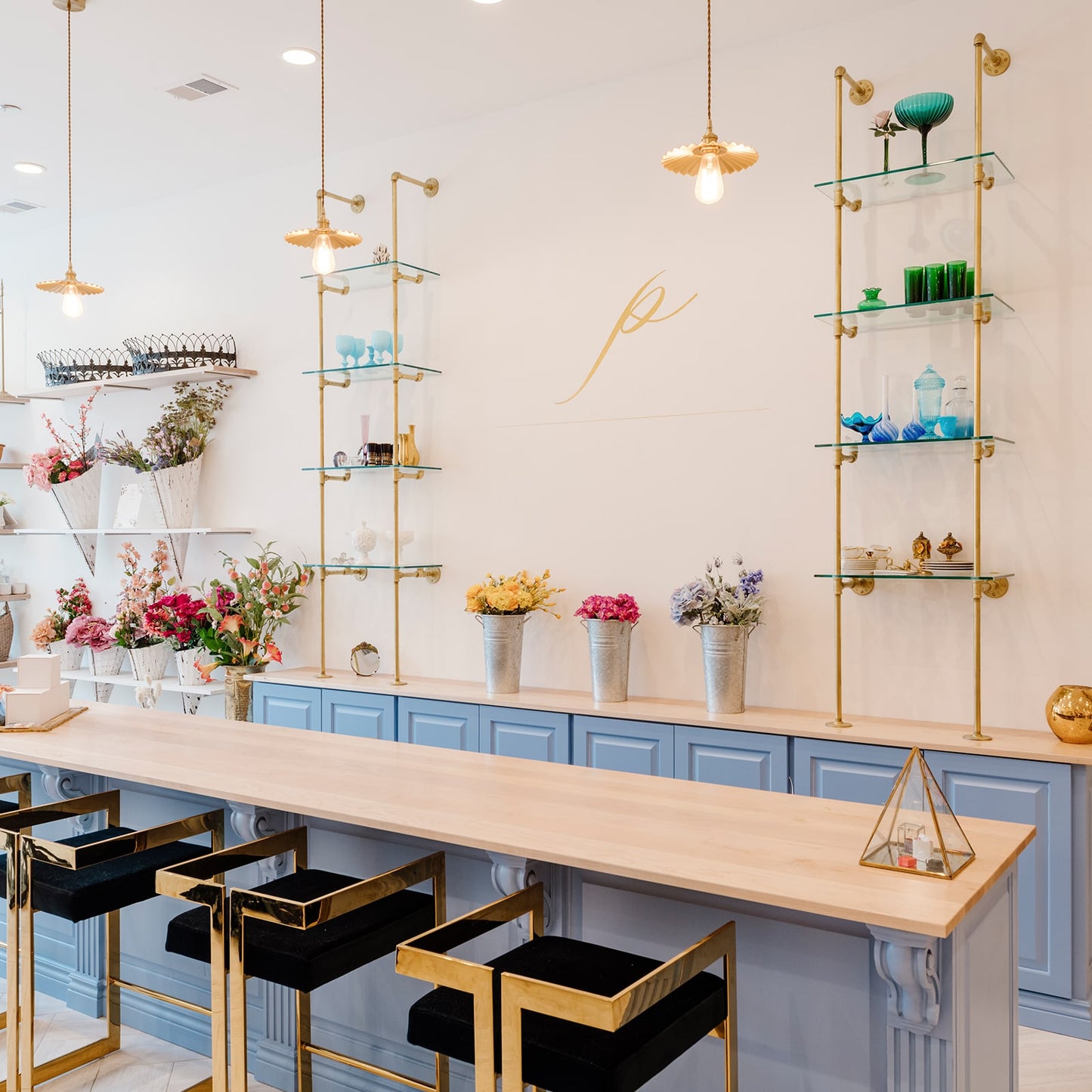 custom retail shelving units with brass plated pipes and glass shelves | Soil & Oak