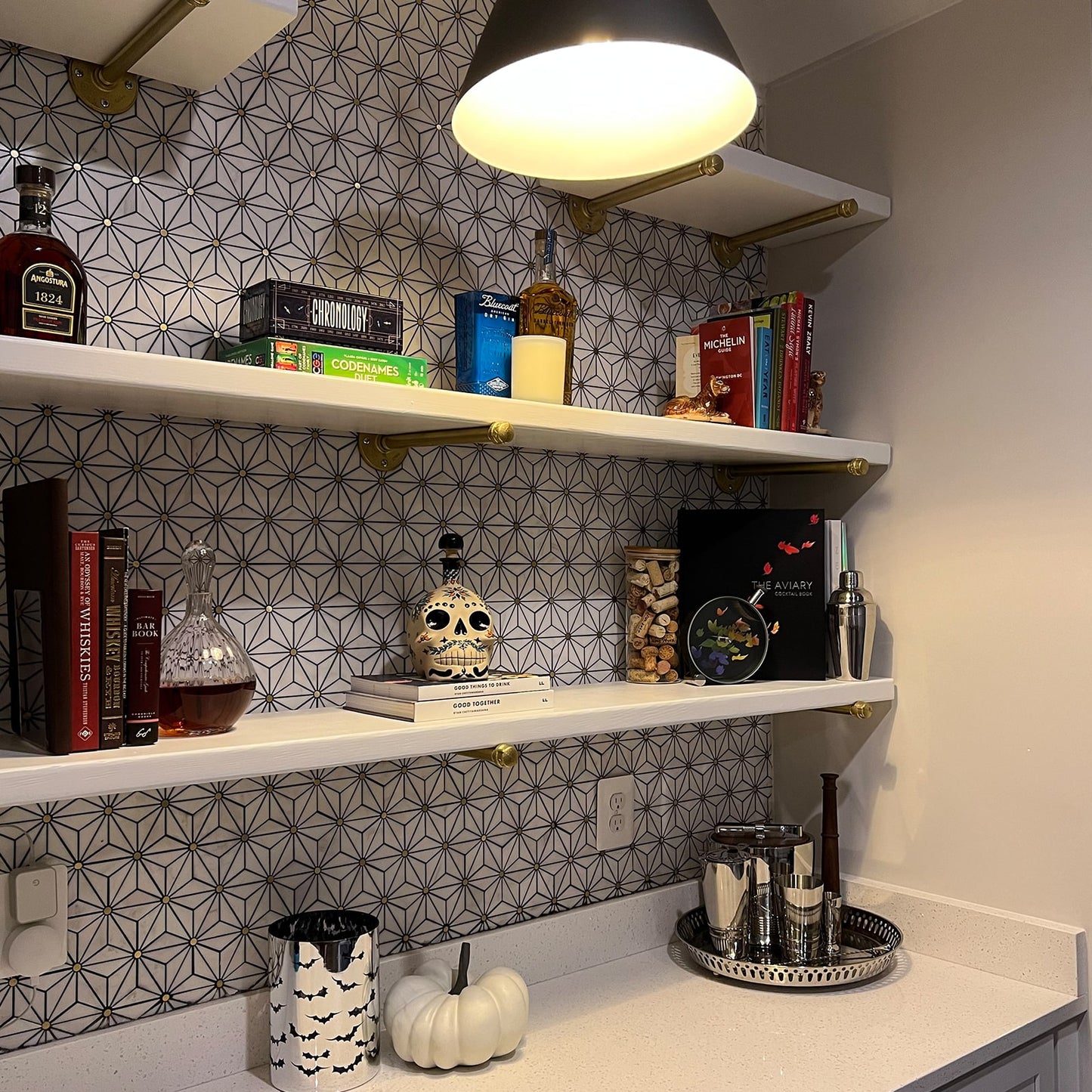 close up of soil & oak brass plated wall mounts with white shelves