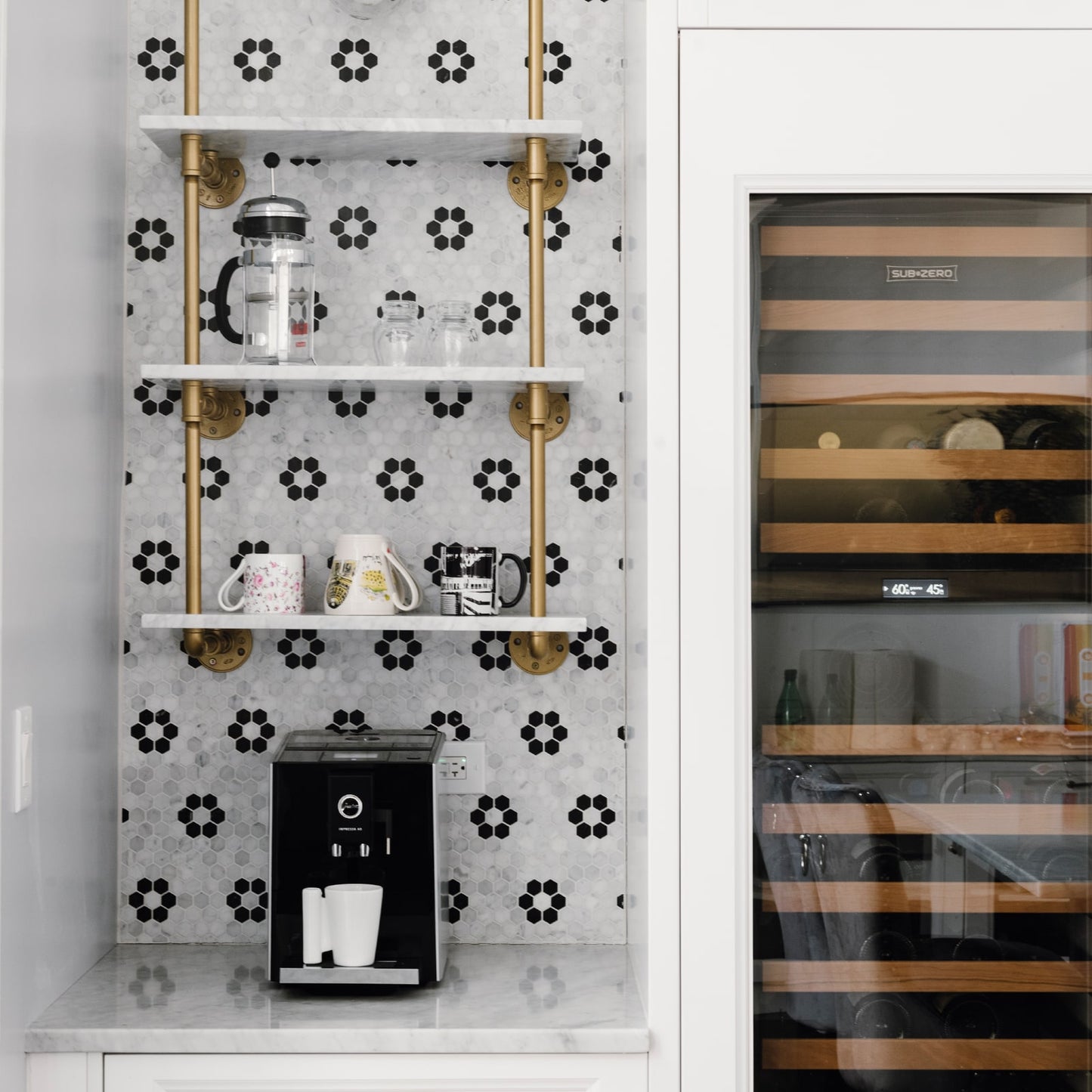 small ceiling to wall bar and kitchen shelving with black pipes and glass shelves next to wine cooler | Soil & Oak