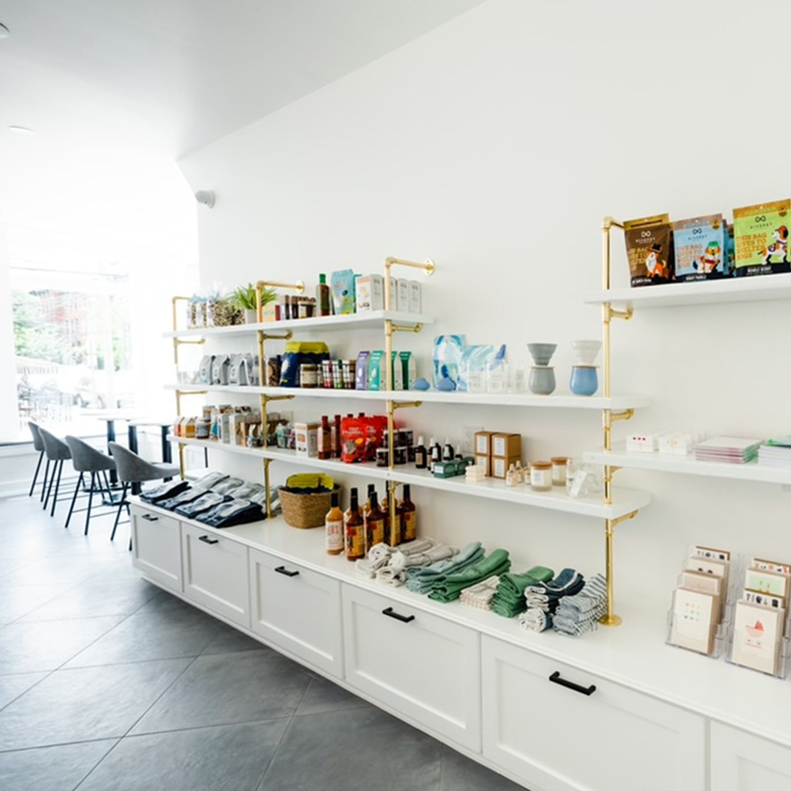 custom white retail shelves with brass plated pipes | Soil & Oak