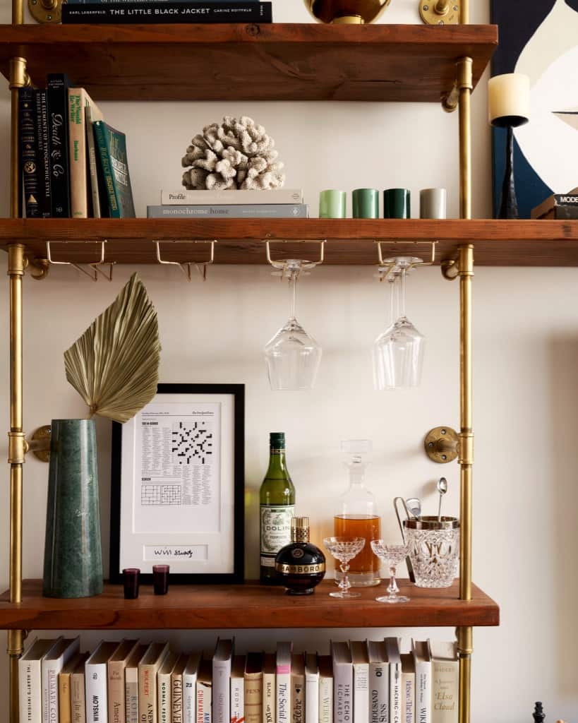 Close up of custom bookshelves brass plated pipe with stained wooden shelves | Soil & Oak