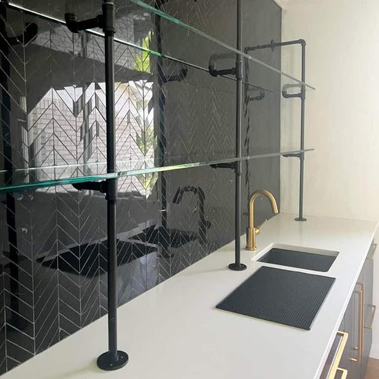 counter to wall unit matte black pipes and glass shelves 