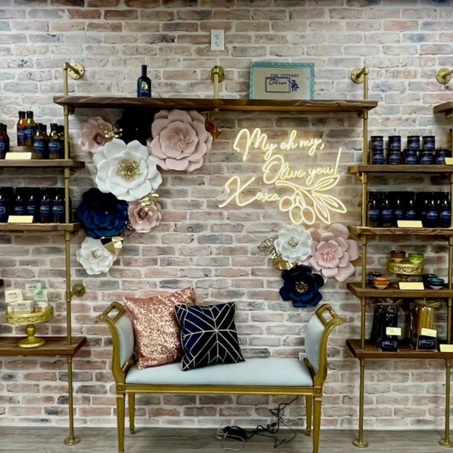 custom bookshelf with brass pipes and oak shelves in a store | Soil & Oak