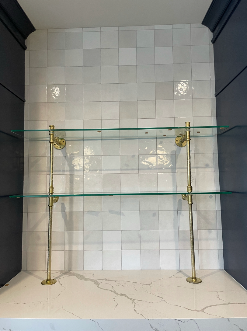 Glass shelves on white tile and marble counter | Soil & Oak