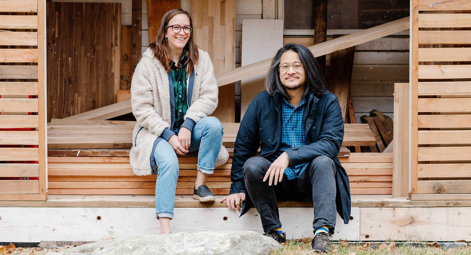 Founders Jay Lee and Caroline Coolidge sitting in front of shelving materials | Soil & Oak 