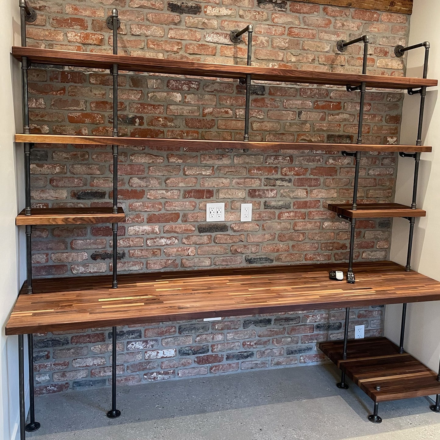 built-in desk with black steel pipes and American walnut wood butcher block shelves in a home office and a printer shelf | Soil & Oak 