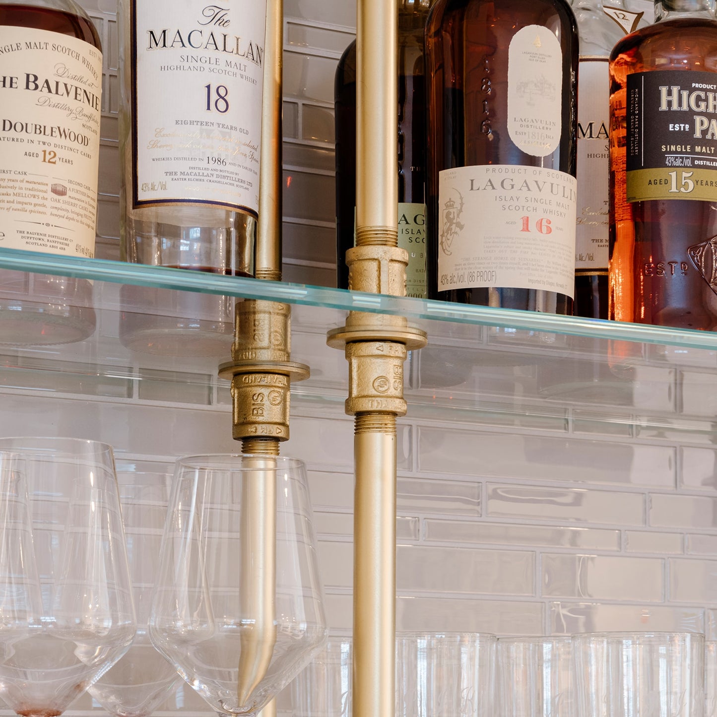 close up photo of brass pipe connection to glass shelves | Soil & Oak 