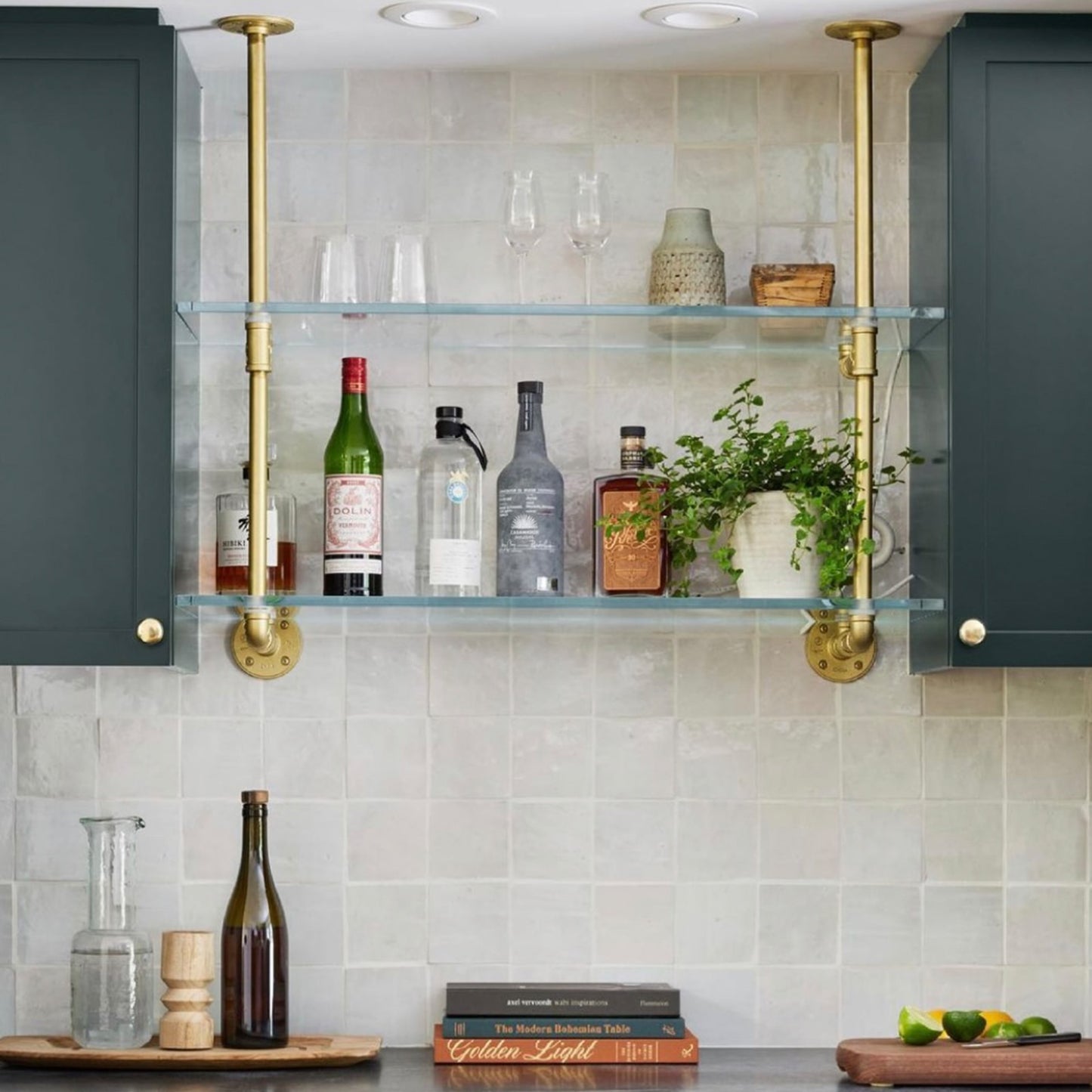 soil & oak small ceiling to wall kitchen shelving with brass plated pipes and glass shelves in between two cabinets
