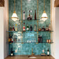 ceiling to wall bar and kitchen shelving with brass plated pipes and glass shelves in front of turquoise tiled bar wall | Soil & Oak 