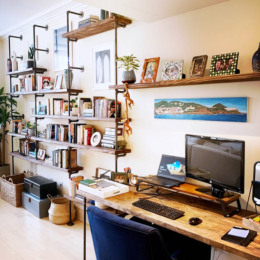 custom bookshelf and built-in desk with black pipes and walnut shelves | Soil & Oak 