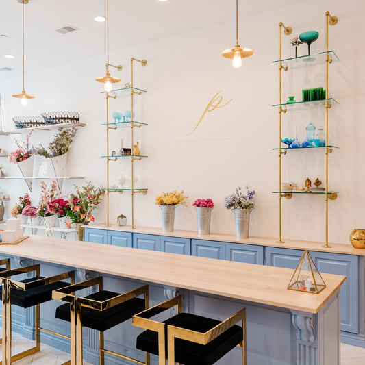 custom retail shelving units with brass plated pipes and glass shelves | Soil & Oak 